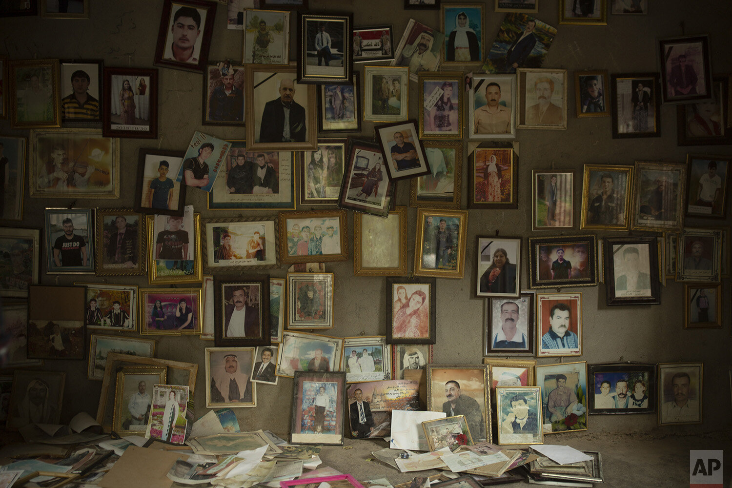  In this Sept. 12, 2019, photo, pictures of Yazidis slain in 2014 by Islamic State militants are found in a small room at the Lalish shrine in northern Iraq. When Yazidis were seized alive by the militants, top commanders registered them, photographe