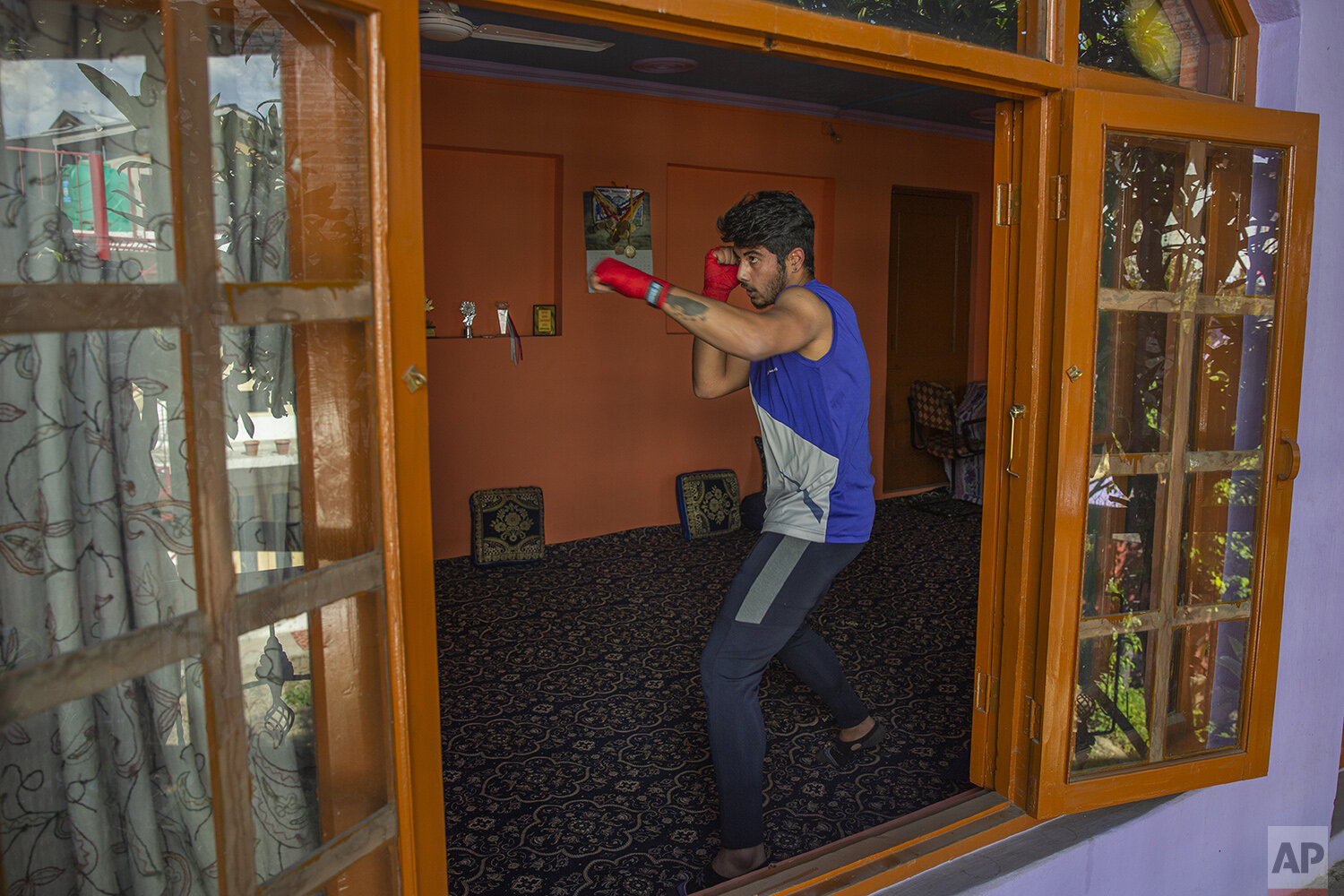  Kashmiri boxer Eyed Akeel Khan practices inside his house in Srinagar, Indian controlled Kashmir, April 23, 2020. Like many other athletes, the coronavirus pandemic has restricted Khan to his home. But lockdown for the 7 million residents of Kashmir