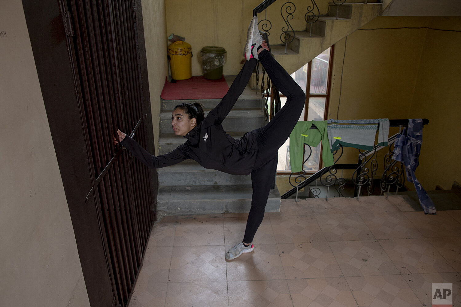  Kashmiri Taekwondoin Afreen Hyder practices in her apartment's corridor in Srinagar, Indian controlled Kashmir, April 19, 2020. The 20-year-old martial arts player shares a two-bedroom apartment with her parents in the region’s main city of Srinagar