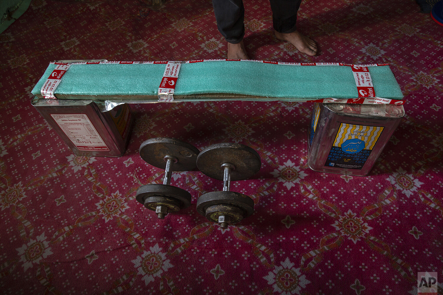  Weights lie next to a makeshift bench of tin boxes and wooden plank covered with thermocol inside the room of weightlifter Bashir Ahmed in Srinagar, Indian controlled Kashmir, April 21, 2020. Like many other athletes, the coronavirus pandemic has re