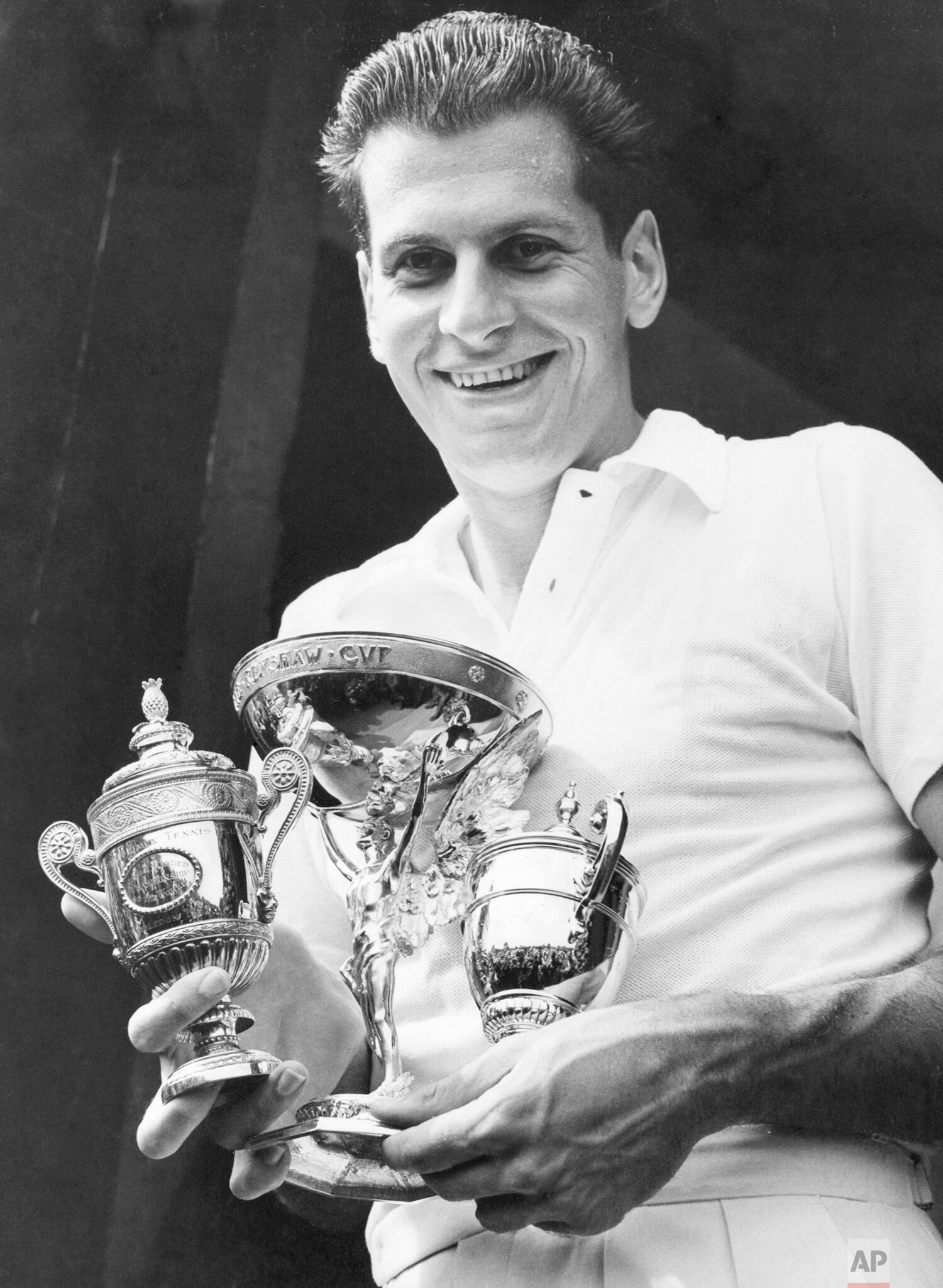  Dick Savitt of Orange, New Jersey, holds the three cups presented to him after winning the men's singles title at the All England Lawn Tennis Championships in Wimbledon on July 6, 1951. He beat Australia's Ken McGregor, unseen, 6-4, 6-4, 6-4 in the 