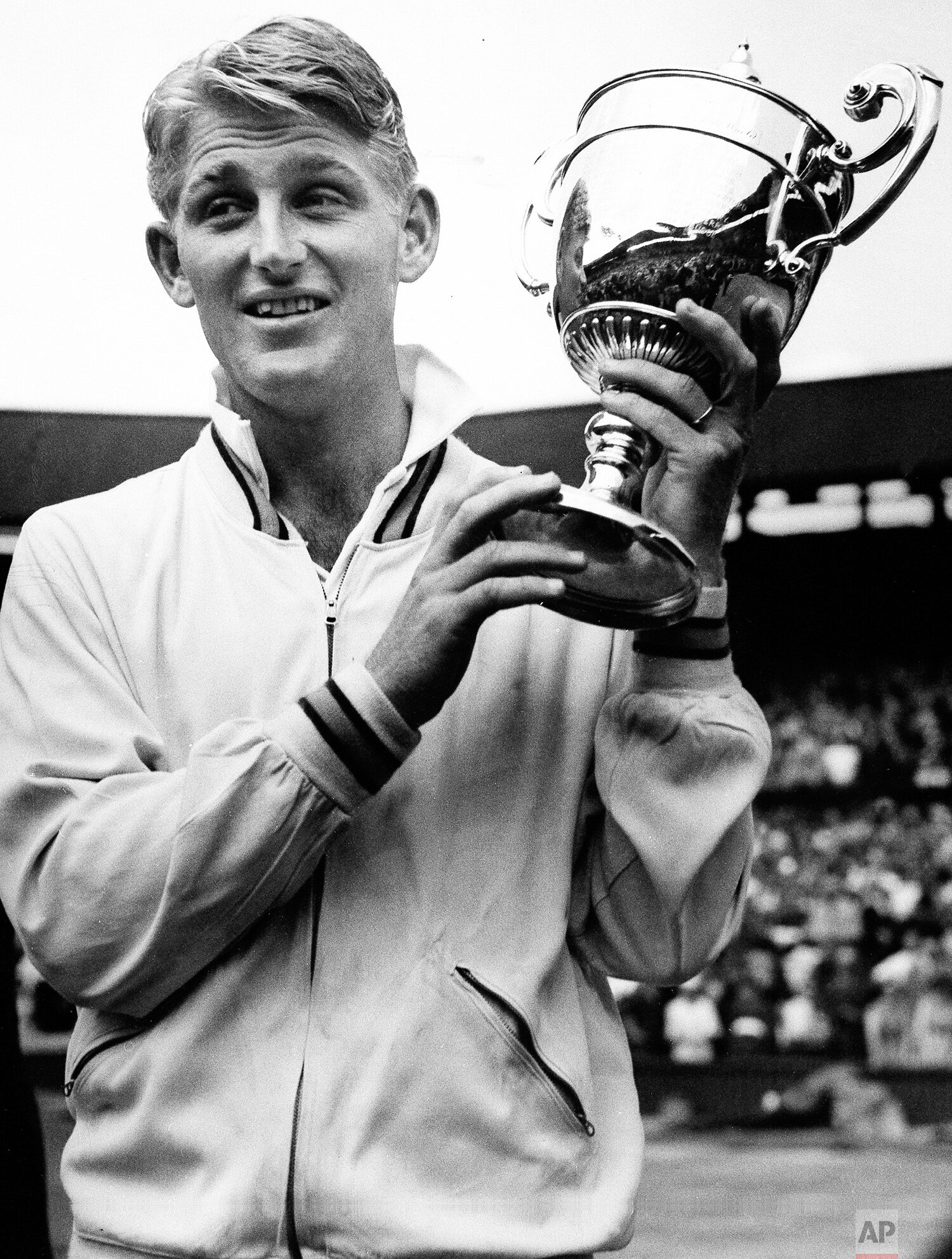  Lew Hoad shows off the trophy presented to him by the Duchess of Kent after he defeated fellow Australian Ken Rosewall in the final of the men's singles championship at Wimbledon, July 6, 1956.  (AP Photo) 