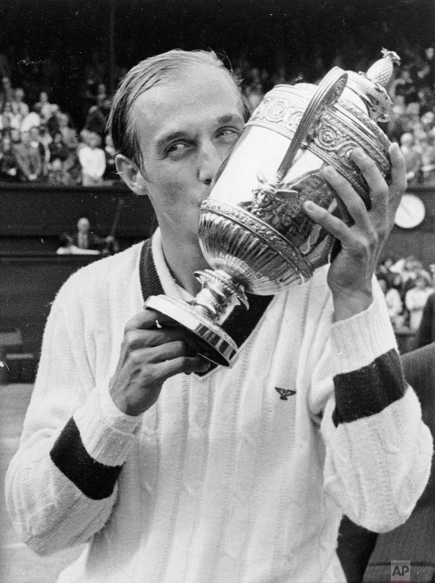  Stan Smith of the U.S. kisses the cup presented to him by the Duke of Kent after he defeated Romania's Ilie Nastase in the final of the men's singles championship, July 9, 1972. (AP Photo) 