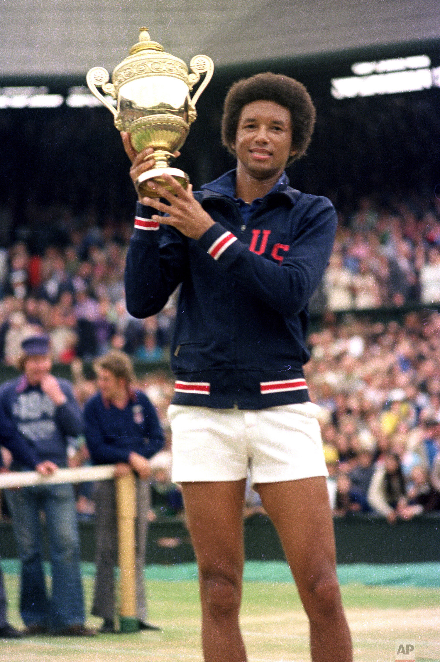 Arthur Ashe holds his Wimbledon trophy cup after defeating fellow American Jimmy Connors in the final match of the men's singles championship at the All England Lawn Tennis Championship in Wimbledon, England, July 5, 1975. (AP Photo) 
