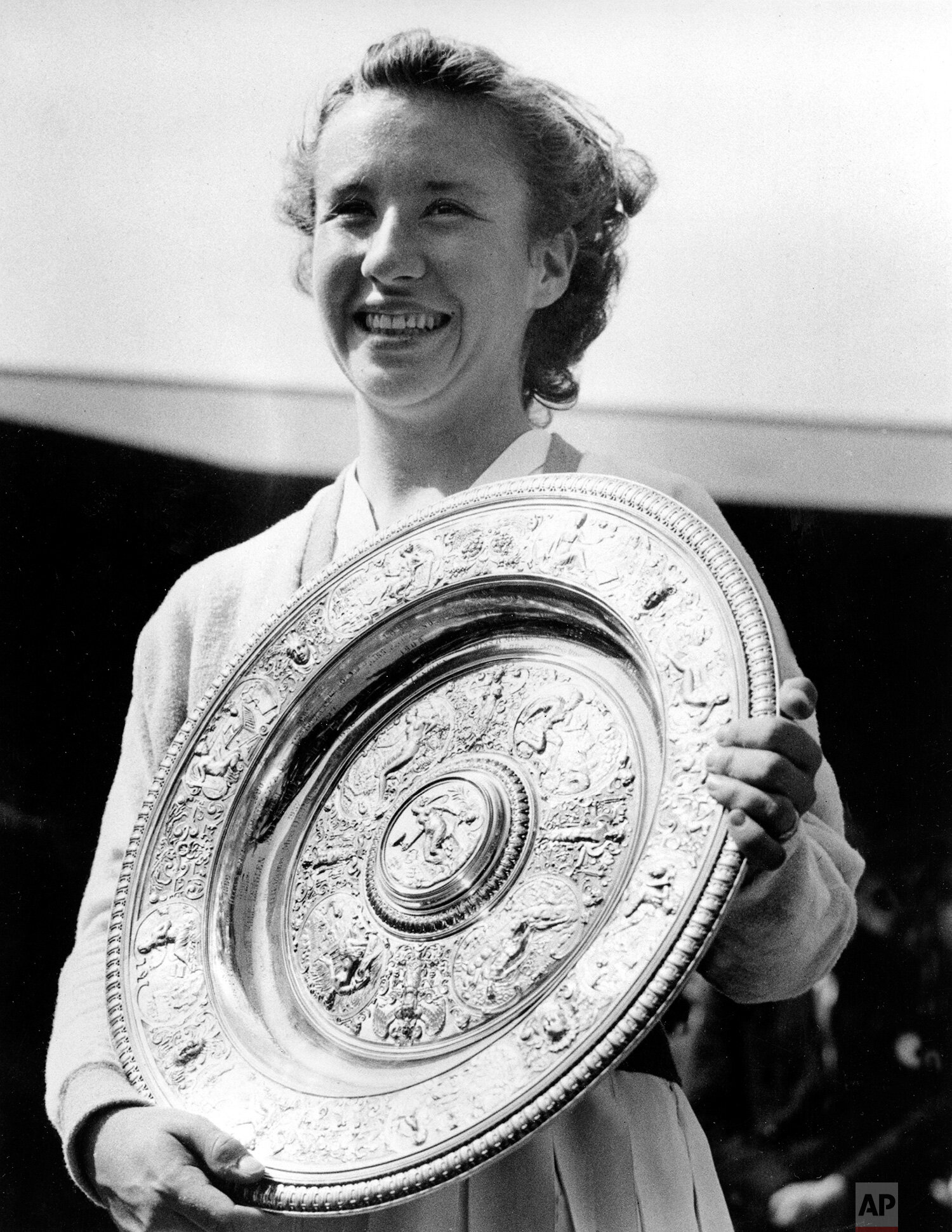  Maureen "Little Mo" Connolly, of San Diego, Ca., smiles as she holds her challenge trophy after winning the final in the women's singles in the All-England Lawn Tennis Championship at Wimbledon, England, July 5, 1952. The 17-year-old defeated Louis 