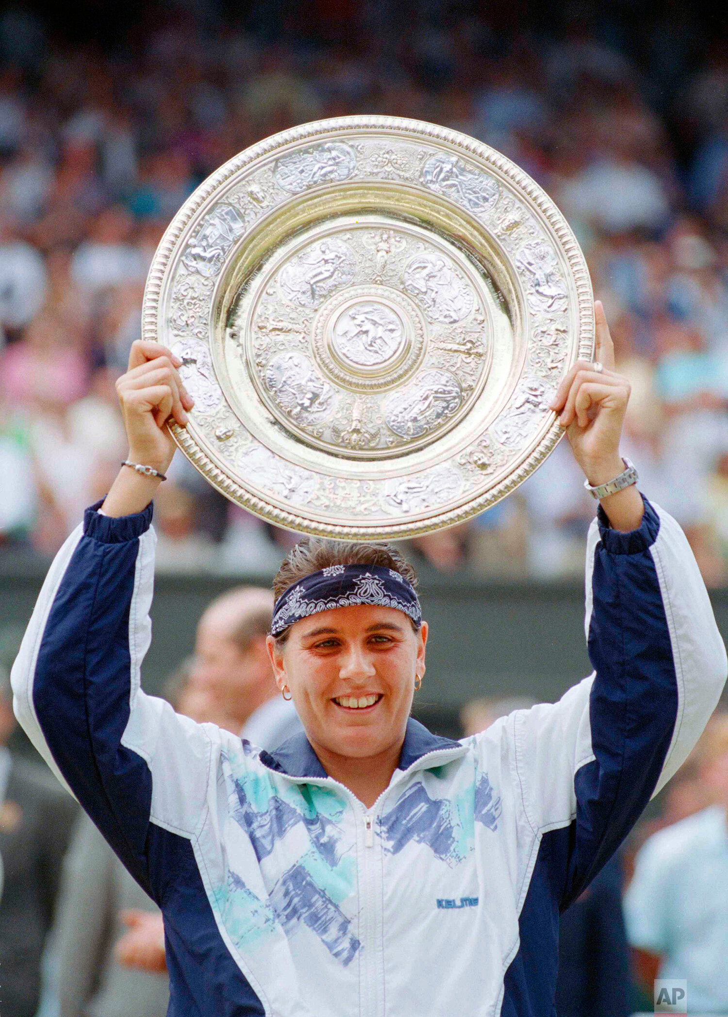  Conchita Martinez holds up the trophy after winning the ladies singles final on the Centre Court at Wimbledon, July 2, 1994. Martinez defeated Martina Navratilova, 6-4, 3-6, 6-3, to win the championship. (AP Photo/Dave Caulkin) 