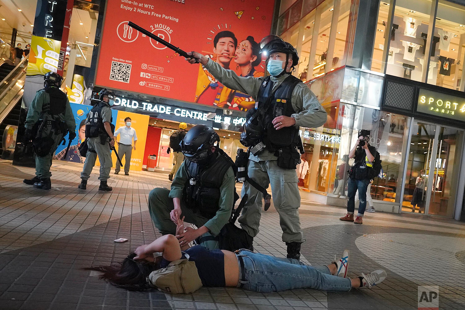  Riot police detain a protester during a protest in Causeway Bay, Hong Kong, Friday, June 12, 2020, over the recent passage of legislation requiring the semi-autonomous territory of Hong Kong to implement a national security law. (AP Photo/Vincent Yu