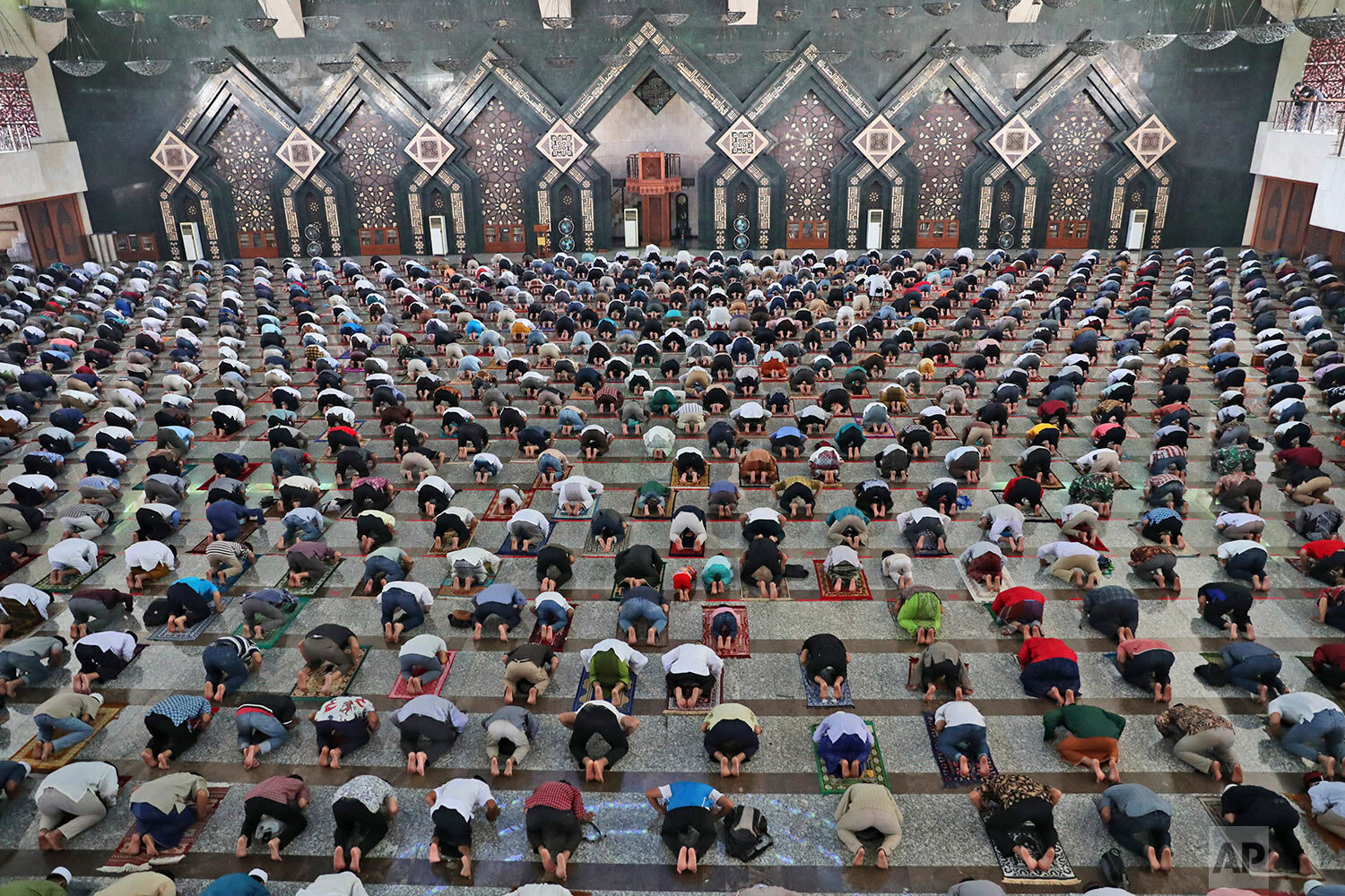  Muslim men pray spaced apart amid coronavirus concerns during a Friday prayer at At-Tin mosque in Jakarta, Indonesia, Friday, June 5, 2020. (AP Photo/Achmad Ibrahim) 