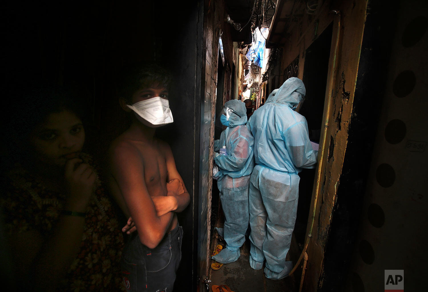  Indian health workers wearing personal protective equipment perform door to door check ups at a slum in Mumbai, India, Wednesday, June 17, 2020. (AP Photo/Rafiq Maqbool) 