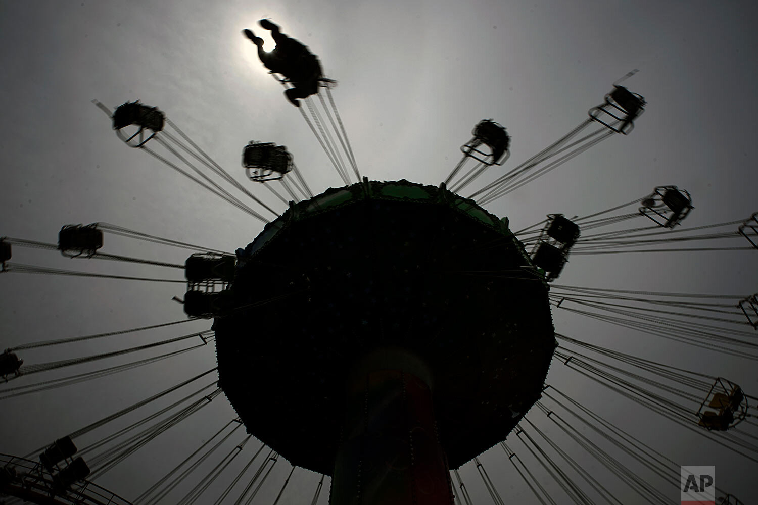  A visitor enjoys a swing ride at the Yomiuriland amusement park in Tokyo, Tuesday, June 16, 2020.  (AP Photo/Eugene Hoshiko) 