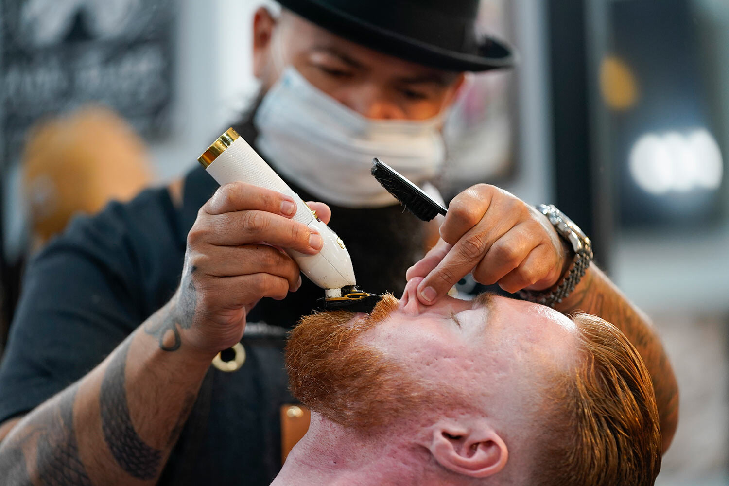  Braunson McDonald has his beard trimmed by Luis Lopez, owner of Orange County Barbers Parlor, on Wednesday, July 15, 2020, in Huntington Beach, Calif. Gov. Gavin Newsom this week ordered that indoor businesses like salons, barber shops, restaurants,