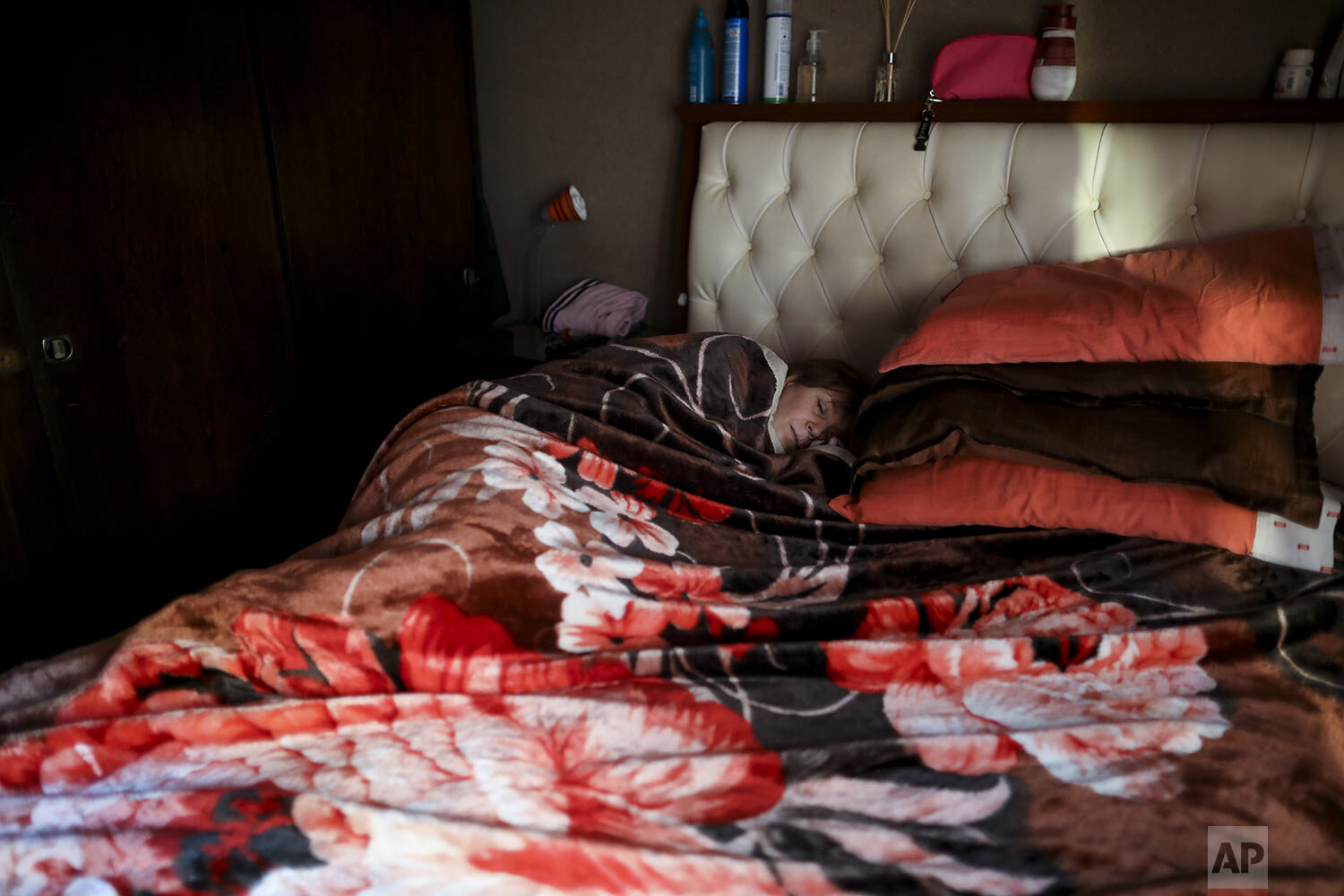  Andrea Cortes, a 49-year-old nurse, rests in her home in Buenos Aires, Argentina, Monday, July 13, 2020, during a government-ordered lockdown to curb the spread of the new coronavirus. (AP Photo/Natacha Pisarenko) 