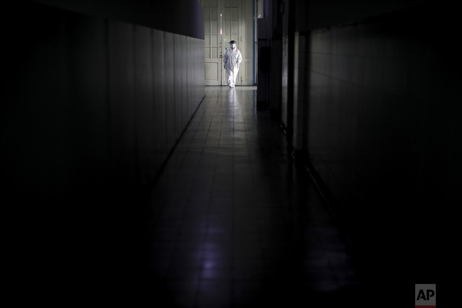  Andrea Cortes walks in the hallway of the Hospital Pineiro where she works as a nurse in Buenos Aires, Argentina, Friday, July 17, 2020. (AP Photo/Natacha Pisarenko) 