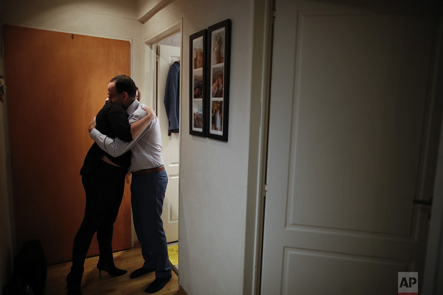  Dr. Matias Norte embraces his wife Silvina in a hallway of their apartment in the western suburbs of Buenos Aires, Argentina, Saturday, July 18, 2020, after a long day of treating COVID-19 patients but no kissing or hugging until after he has shower