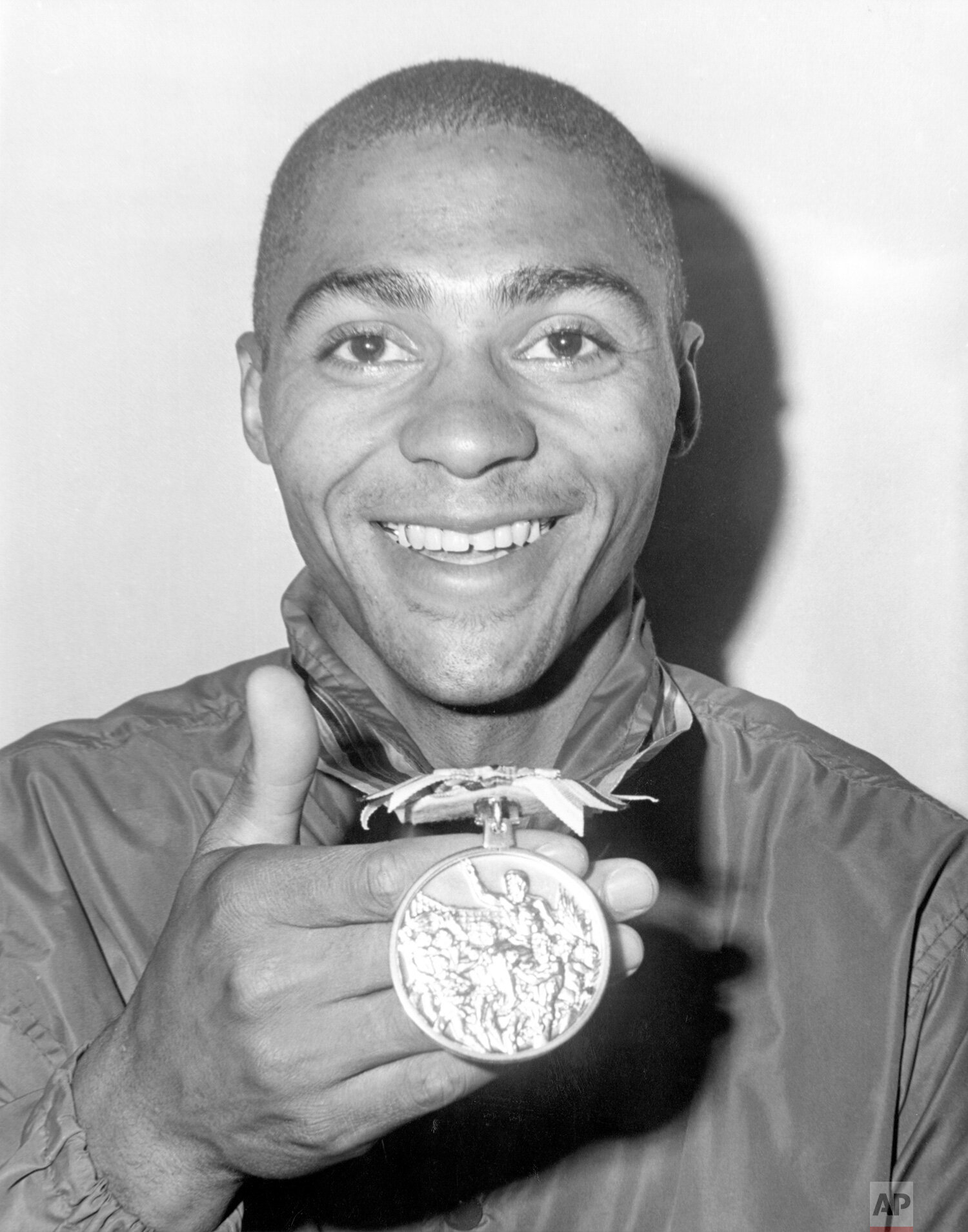  U.S. sprinter Henry Carr displays the gold medal he won in the 200 meter race at the 1964 Olympics in Tokyo, Oct. 17, 1964. (AP Photo) 
