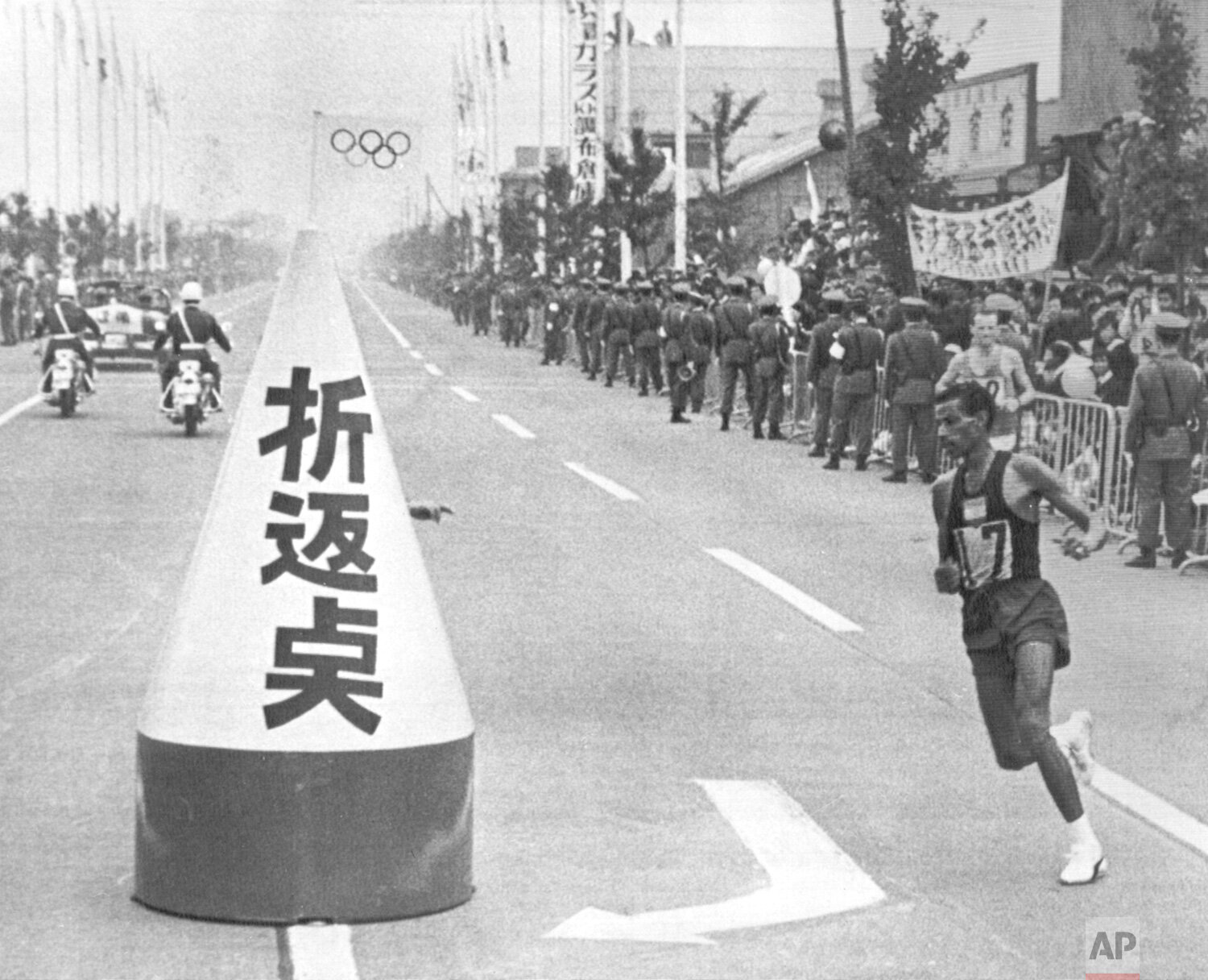  Abebe Bikila of Ethiopia circles the half-way mark set up at Tokyo's Koshu Highway during the Olympic marathon race which he won on Oct. 21, 1964.  Bikila, a 32-year-old guard at the palace of Ethiopian Emperor Haile Selassie, ran the 26 miles, 385 