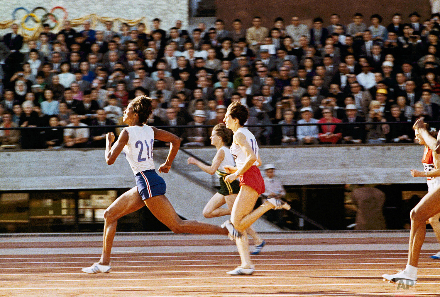  Edith McGuire, left, leads the women's 200 meter race at the 1964 Summer Olympics in Tokyo.  Second is Irena Kirszenstein and third is Marilyn Black in red shorts. (AP Photo) 