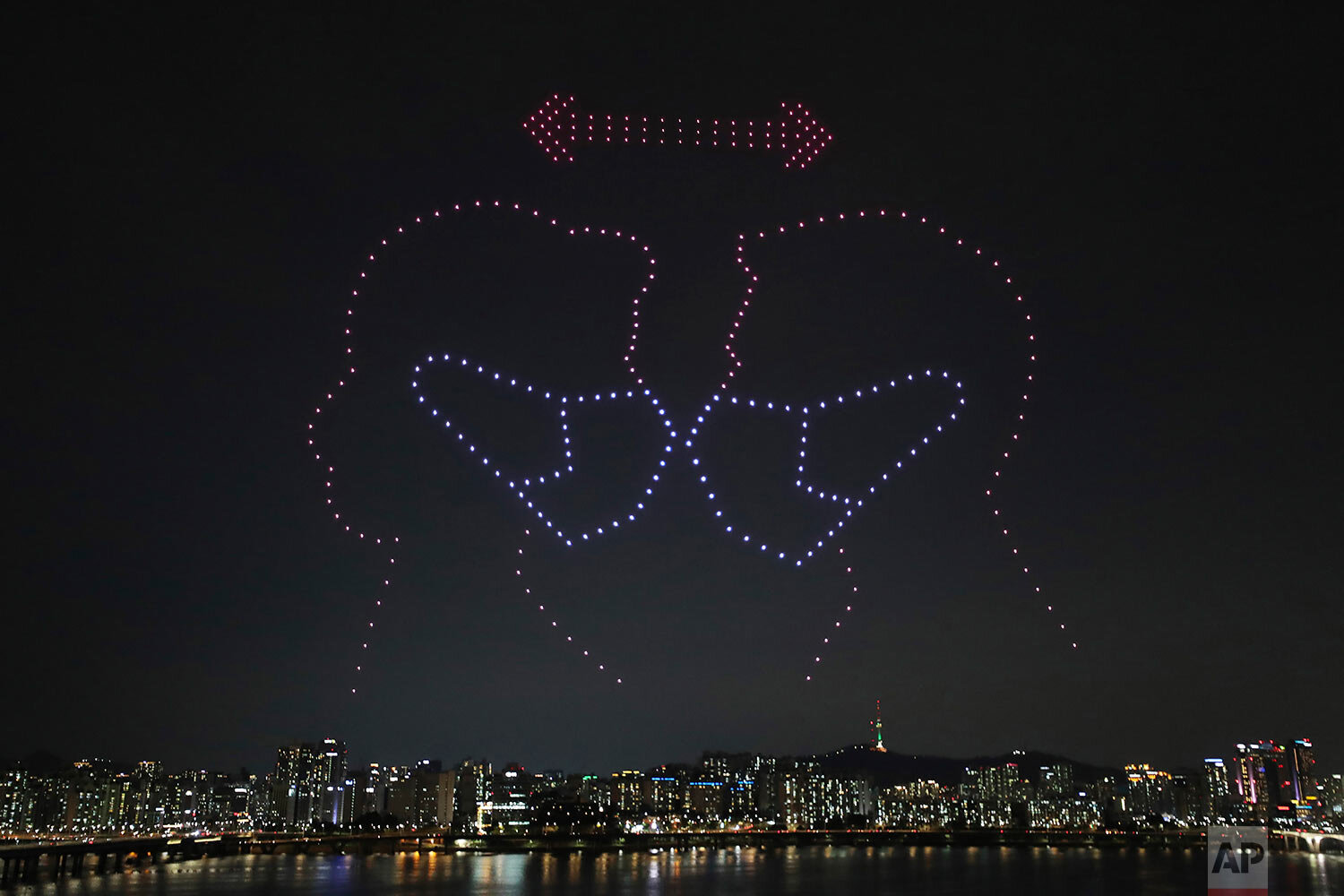  Some 400 drones fly over the Han River showing messages of appreciation for medical workers during the coronavirus pandemic in Seoul, South Korea on Saturday, July 4, 2020. (Lim Hwa-young/Yonhap via AP) 
