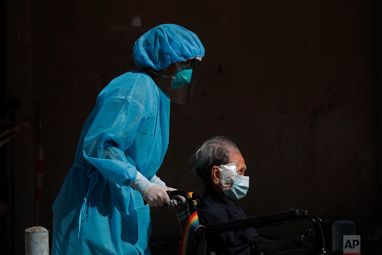  A resident of the nursing home "The Salvation Army Lung Hang Residence for Senior Citizens" is evacuated by medical staff from the Centre for Health Protection, after employees of the nursing home were found to have the coronavirus COVID-19, in Hong