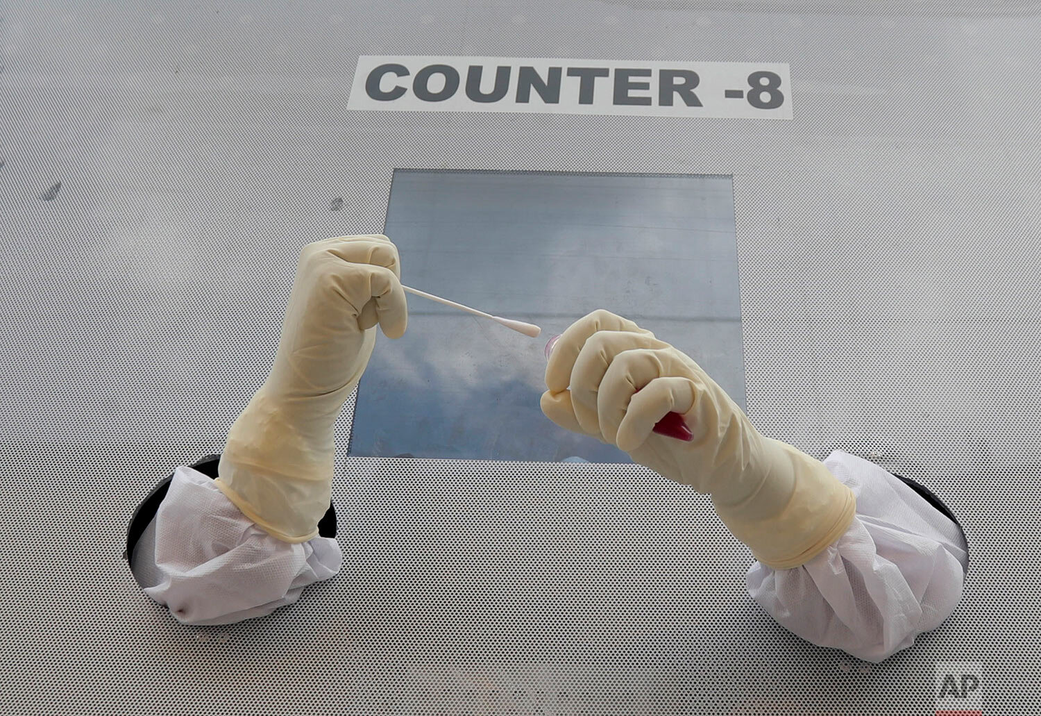  A health worker prepares to collect nasal swab samples for COVID-19 tests at a mobile testing centre in Hyderabad, India, Friday, July 31, 2020.  (AP Photo/Mahesh Kumar A.) 