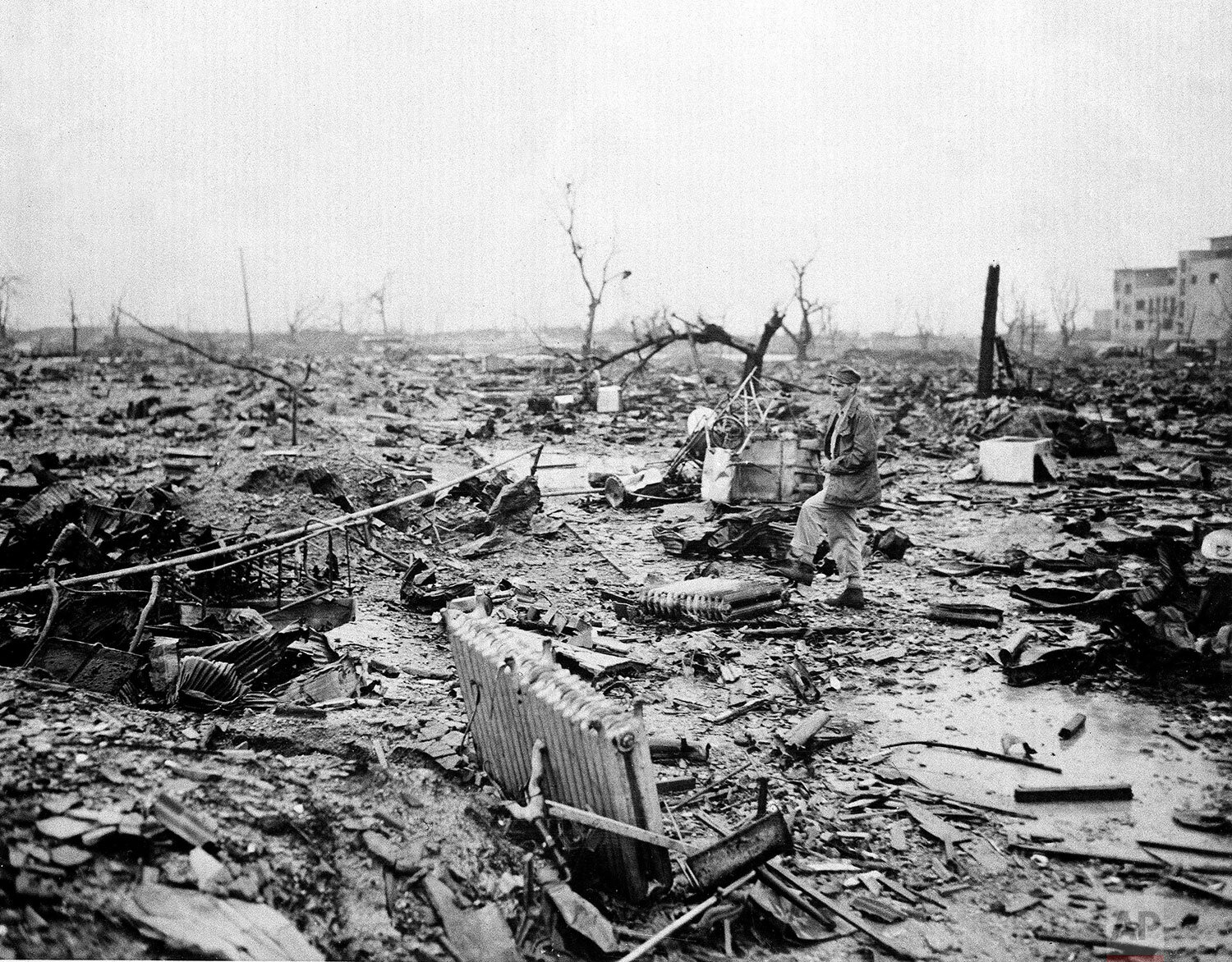  About one month after the dropping of the first atomic bomb on Aug. 6, 1945, an allied correspondent examines the landscape of destruction at Hiroshima, Japan. (AP Photo) 