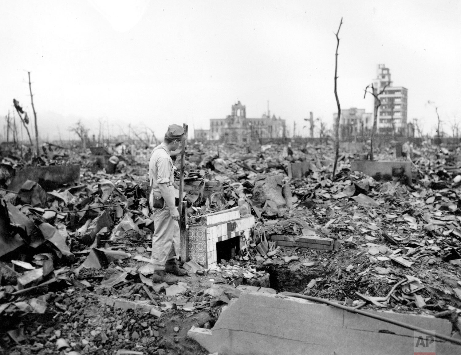  An unidentified man stands next to a tiled fireplace where a house once stood in Hiroshima, Japan, on Sept. 7, 1945.  The vast ruin is a result of "Little Boy," the uranium atomic bomb detonated on Aug. 6 by the U.S., leading to the end of World War