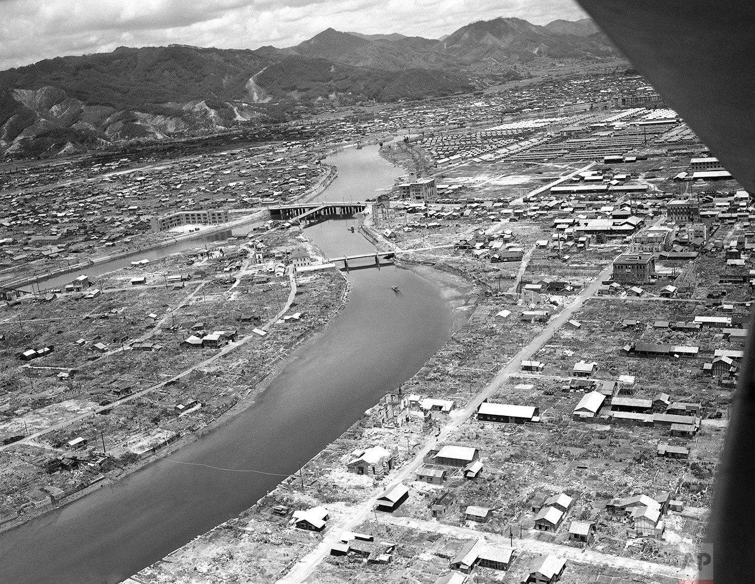  This air view looks toward the center of Hiroshima, Japan and the “T” shaped bridge on July 21, 1947, which was the landmark for the bombing run. (AP Photo/Charles Gorry) 