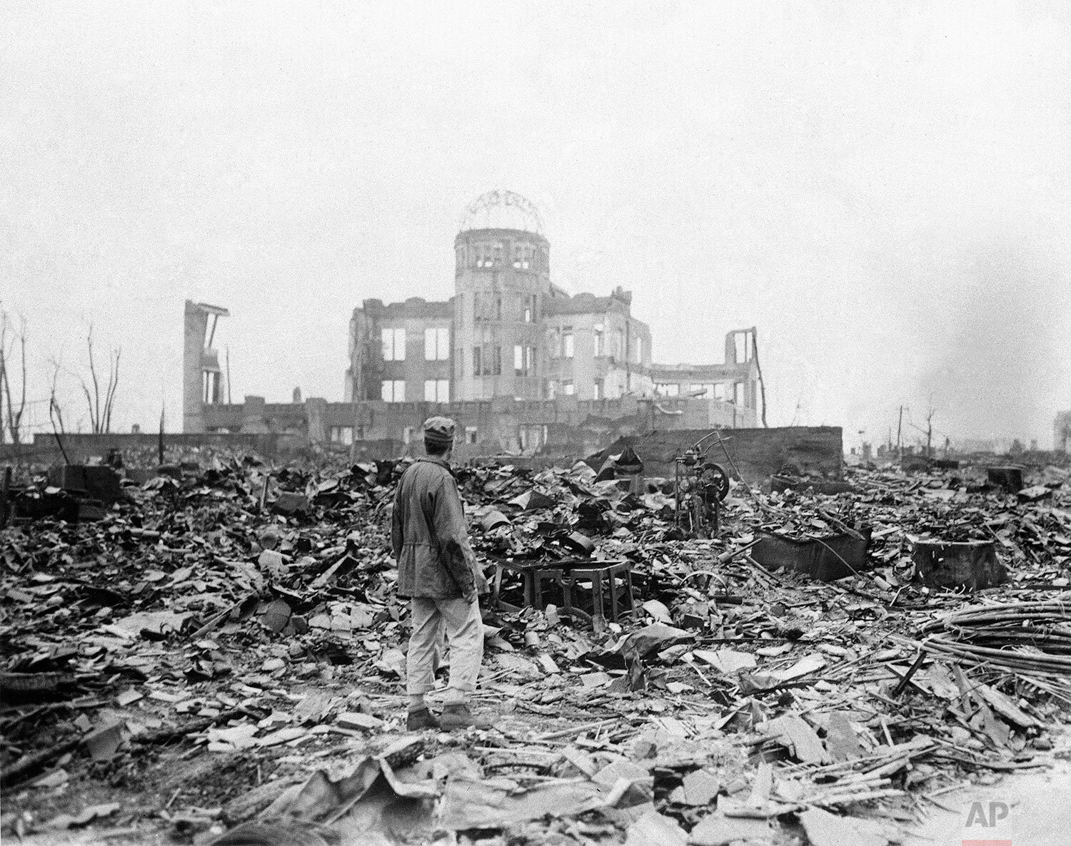  An allied correspondent stands in a sea of rubble before the shell of a building that once was a movie theater in Hiroshima Sept. 8, 1945, a month after the first atomic bomb ever used in warfare was dropped by the U.S. to hasten Japan's surrender. 