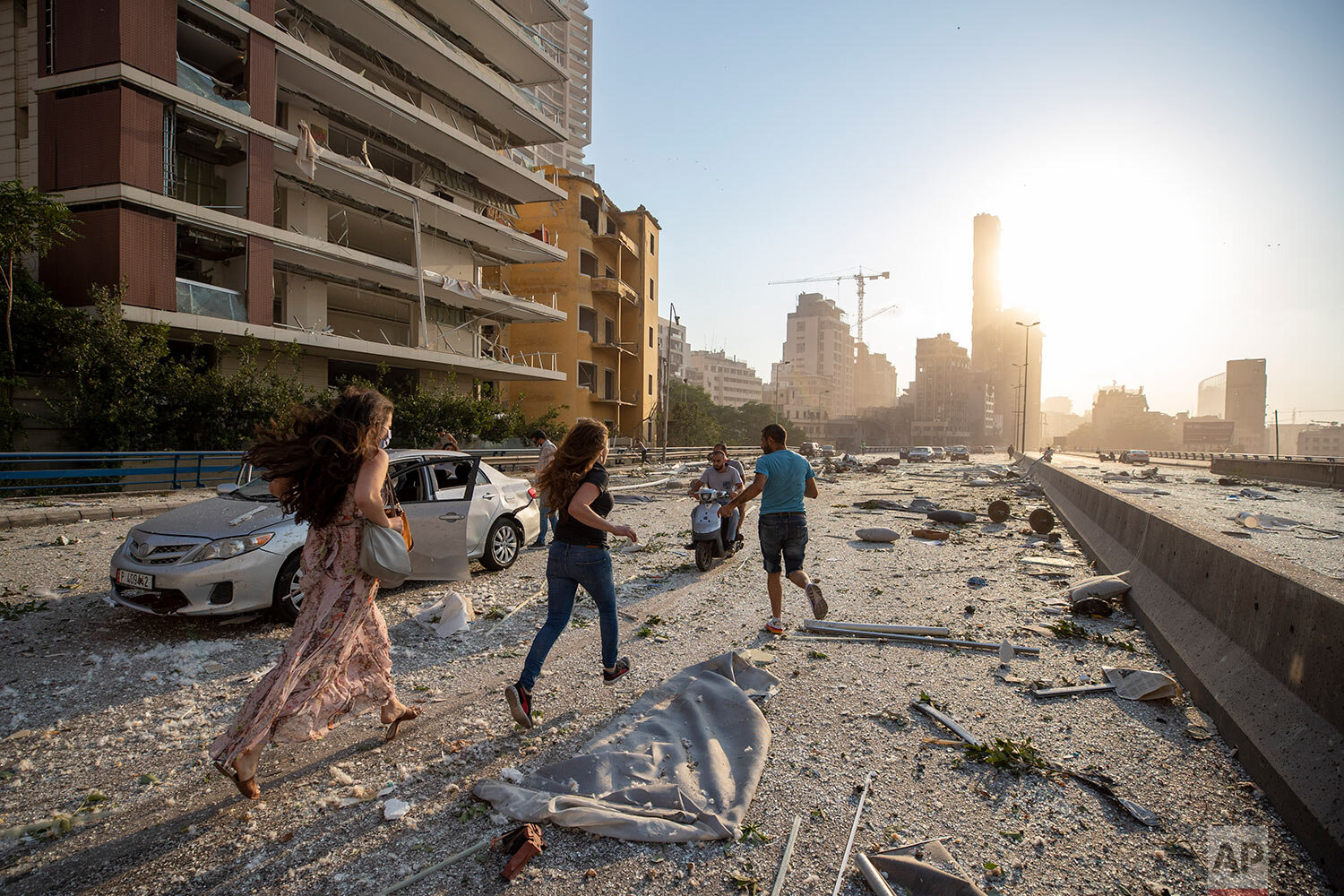  People run in the aftermath of a massive explosion in Beirut, Lebanon, Tuesday, Aug. 4, 2020. (AP Photo/Hassan Ammar) 