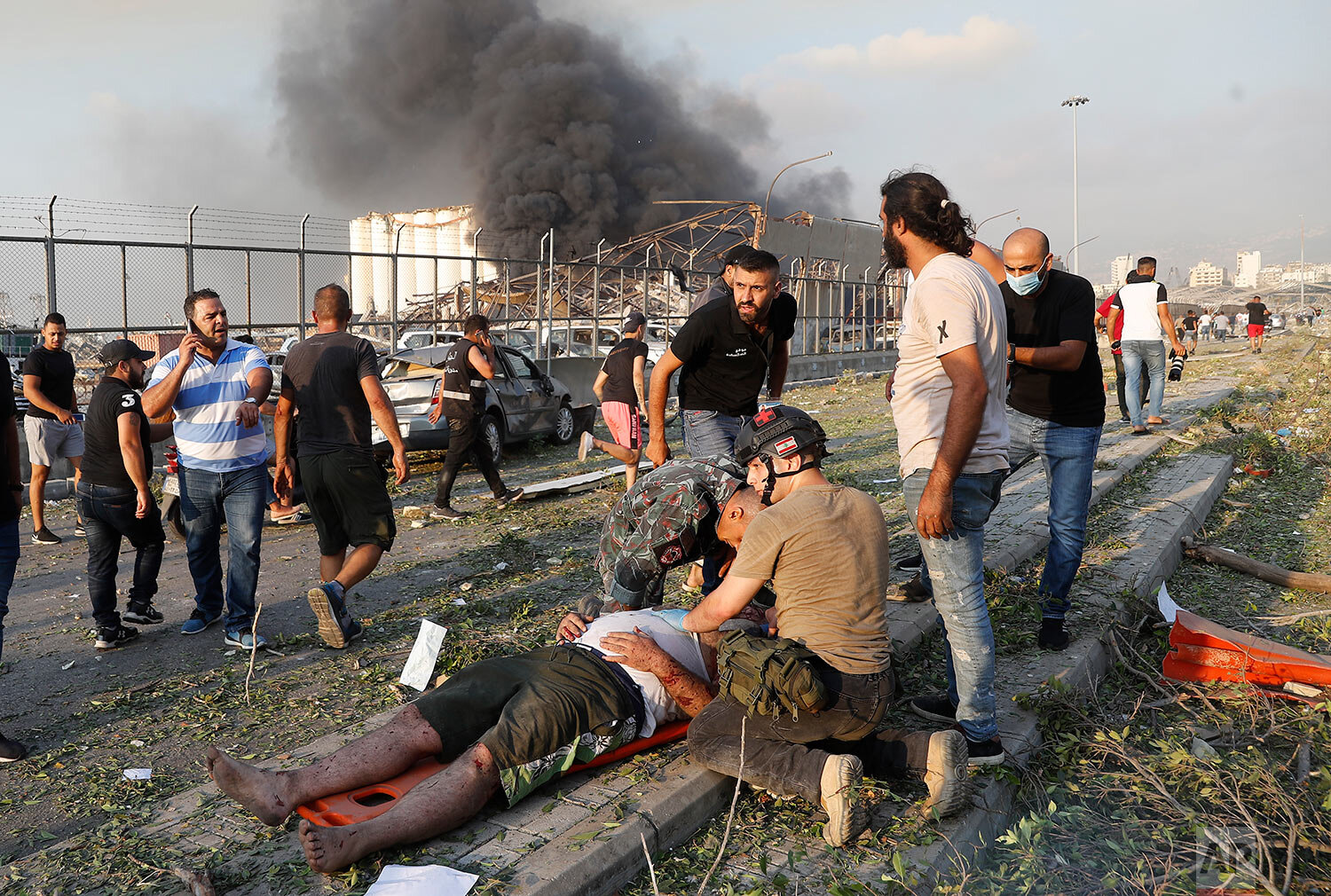  Rescue workers help an injured man at the explosion scene that hit the seaport of Beirut, Lebanon, Tuesday, Aug. 4, 2020. (AP Photo/Hussein Malla) 