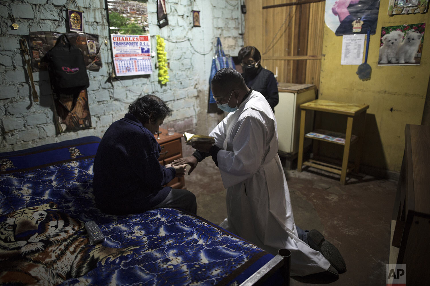  Brother Ronald Marin prays with Jose Munoz who suffers from osteoarthritis, in Comas, on the outskirts of Lima, Peru, Thursday, July 23, 2020. (AP Photo/Rodrigo Abd) 