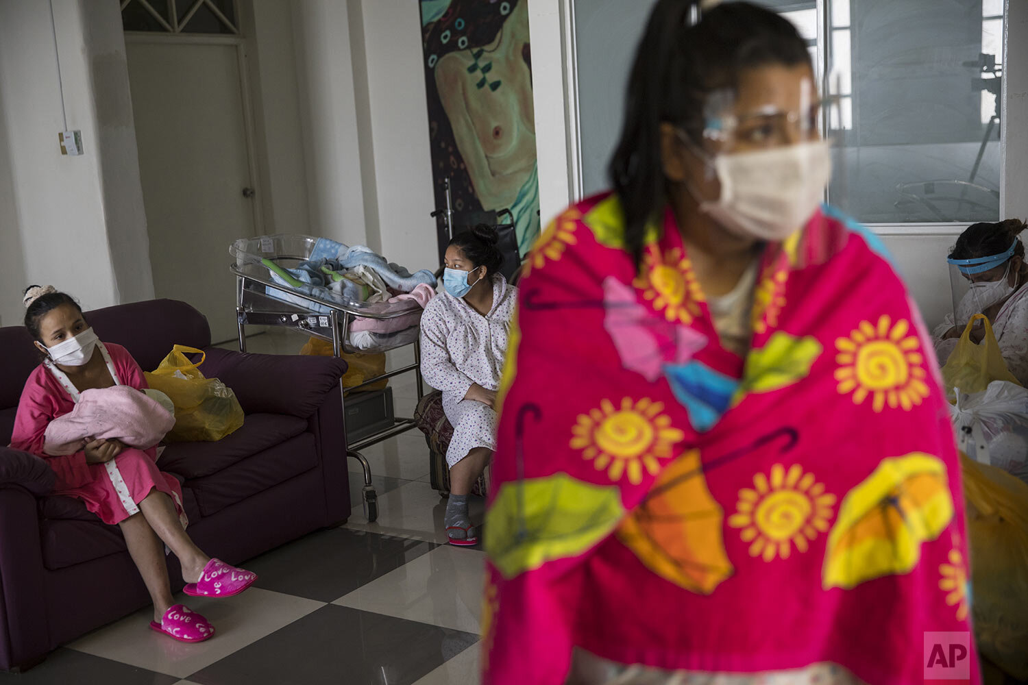  Maria Alvarez sits on a sofa holding her 1-day-old daughter, in an isolated area reserved for mothers with COVID-19, at the National Maternal Perinatal Institute, in Lima, Peru, Thursday, July 30, 2020. (AP Photo/Rodrigo Abd) 