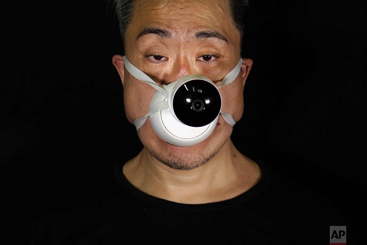  Edmond Kok, a Hong Kong theater costume designer and actor, wearing a face mask with a model CCTV (close circuit television) mounted on it in Hong Kong Thursday, Aug. 6, 2020.  (AP Photo/Vincent Yu) 