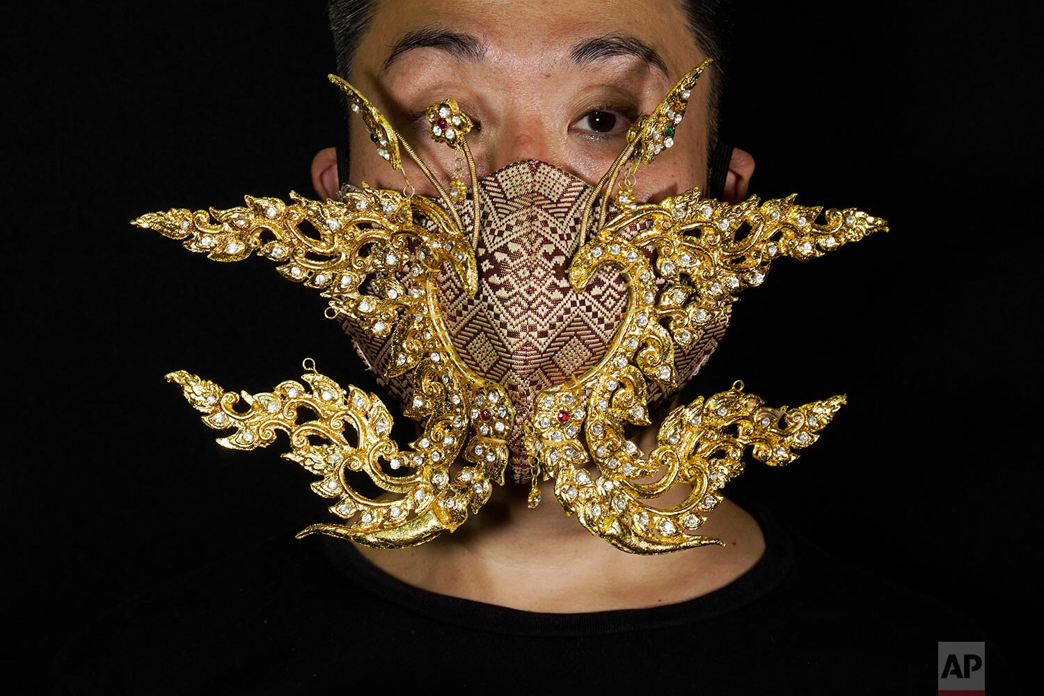  Edmond Kok, a Hong Kong theater costume designer and actor, wearing a face mask inspired by the decoration of Thai temple to Kok's face in Hong Kong Thursday, Aug. 6, 2020. (AP Photo/Vincent Yu) 