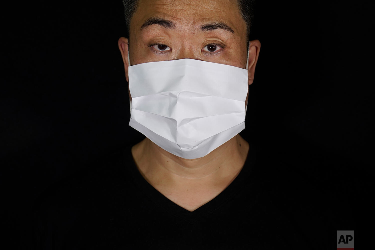  Edmond Kok, a Hong Kong theater costume designer and actor, wearing a face mask made by a white paper in Hong Kong Thursday, Aug. 6, 2020.  (AP Photo/Vincent Yu) 