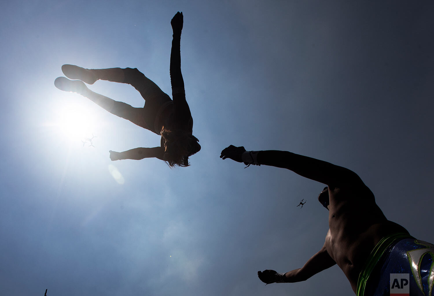  Lucha Libre wrestlers "El Sol," or The Sun, flies over "Gran Felipe Jr." or The Great Felipe Jr., during an exhibition fight for the media as they train for what will be live streaming events which they charge for, at Xochimilco's floating gardens o