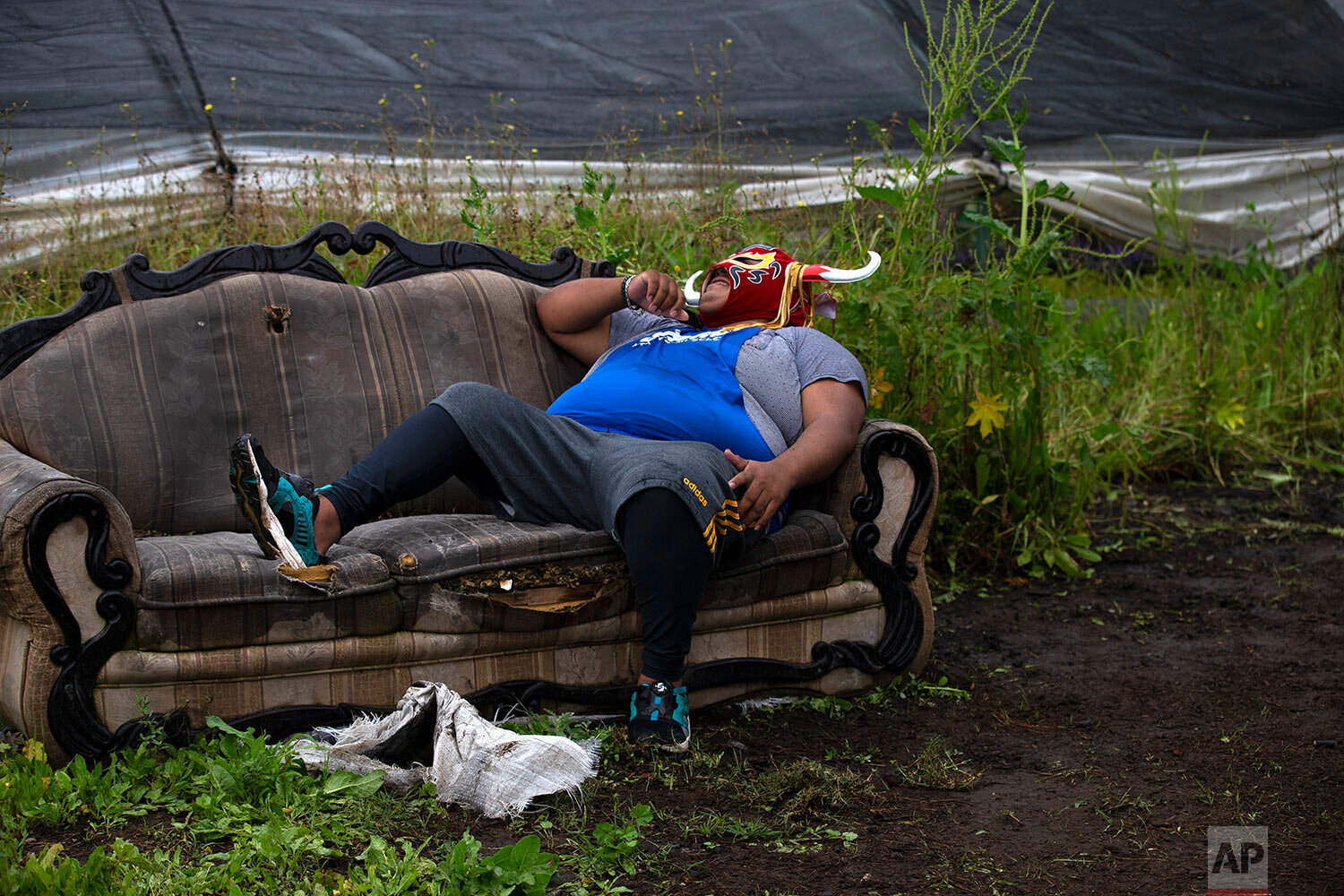  Lucha Libre fighter "Mister Jerry," whose two brothers are also fighters, rests after training amid Xochimilco's famous floating gardens on the outskirts of Mexico City, Thursday, Aug. 20, 2020. (AP Photo/Marco Ugarte) 