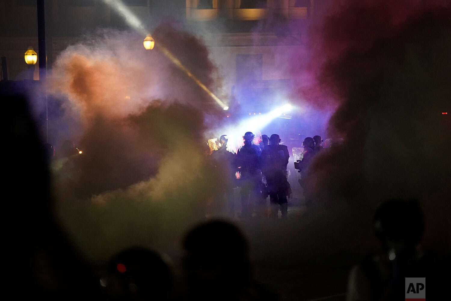  Police in riot gear clear the area in front of Kenosha County Courthouse during clashes with protesters late Tuesday, Aug. 25, 2020, in Kenosha, Wis. (AP Photo/David Goldman) 