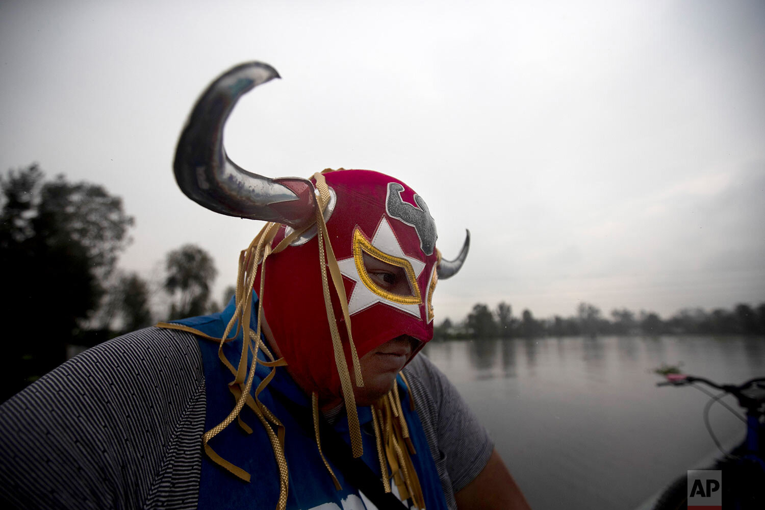  Masked Lucha Libre fighter Mister Jerry rides on a boat to train for what will be live streaming fights which wrestlers will charge for, in Xochimilco's famous floating gardens on the outskirts of Mexico City, Thursday, Aug. 20, 2020, amid the new c