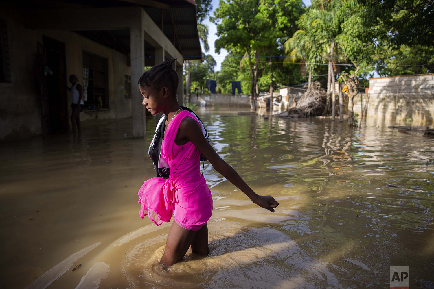  A girl wades to her flooded home the day after the passing of Tropical Storm Laura in Port-au-Prince, Haiti, Aug. 24, 2020. (AP Photo/Dieu Nalio Chery) 