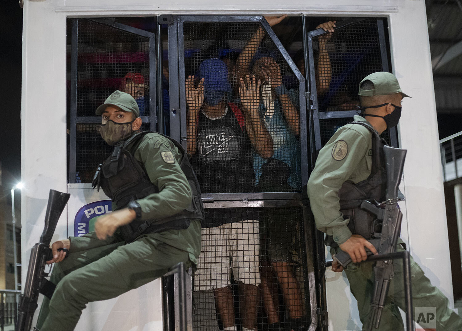  Police take men who were detained for not complying with restrictions by breaking curfew or attending block parties to a coliseum to learn social distancing practices to curb the spread of COVID-19 in the Petare neighborhood of Caracas, Venezuela, A