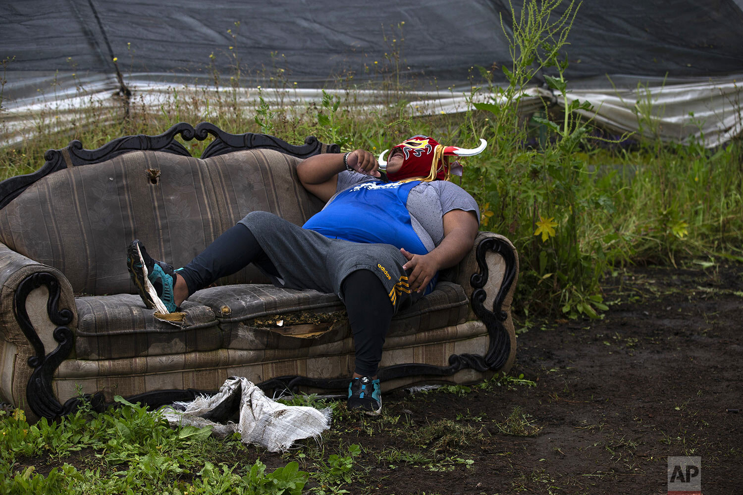  Lucha Libre wrestler "Mister Jerry" rests after training amid Xochimilco's floating gardens on the outskirts of Mexico City, Aug. 20, 2020, by an impromptu ring where he and his two wrestler brothers plan to live stream fights and charge for them, w