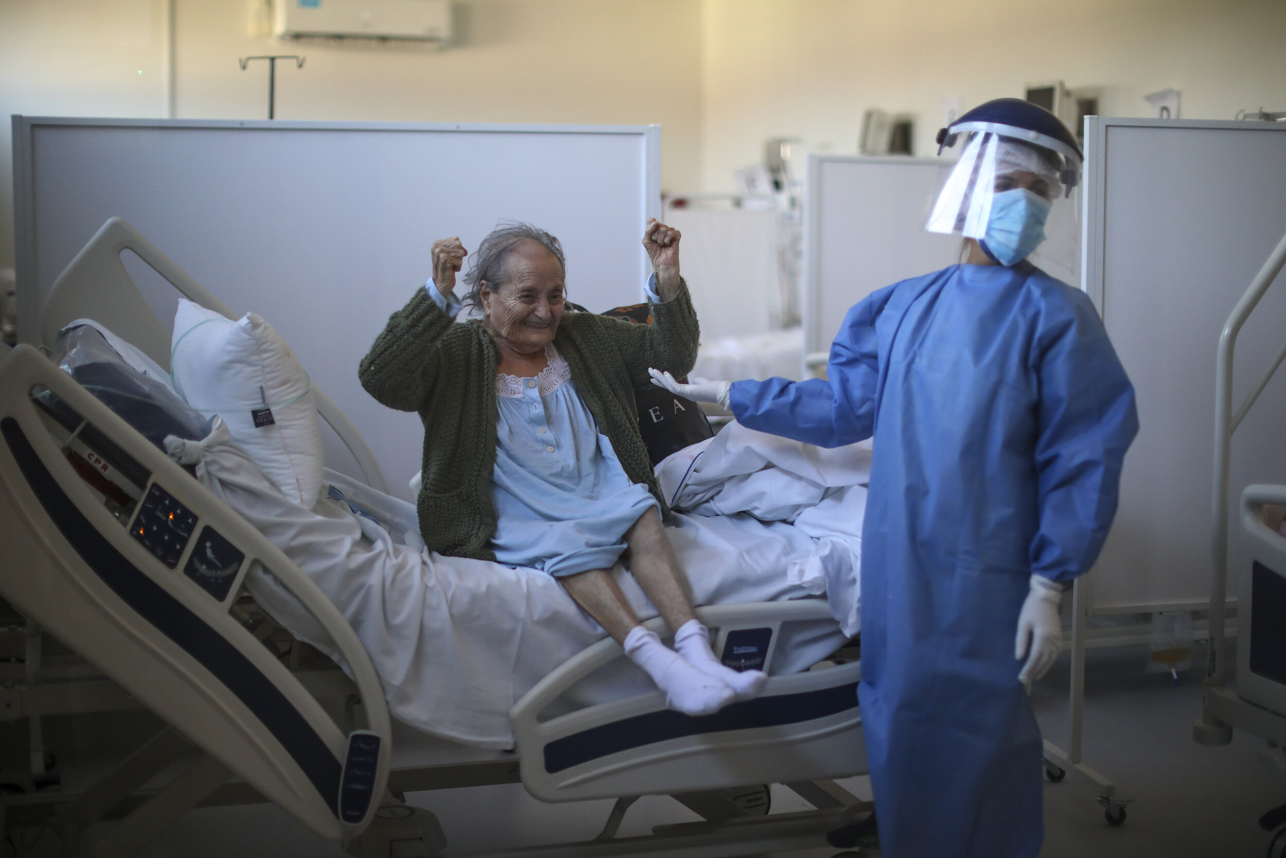  Blanca Ortiz, 84, celebrates after learning from nurses that she will be dismissed from the Eurnekian Ezeiza Hospital, on the outskirts of Buenos Aires, Argentina, Aug. 13, 2020, several weeks after being admitted with COVID-19. (AP Photo/Natacha Pi