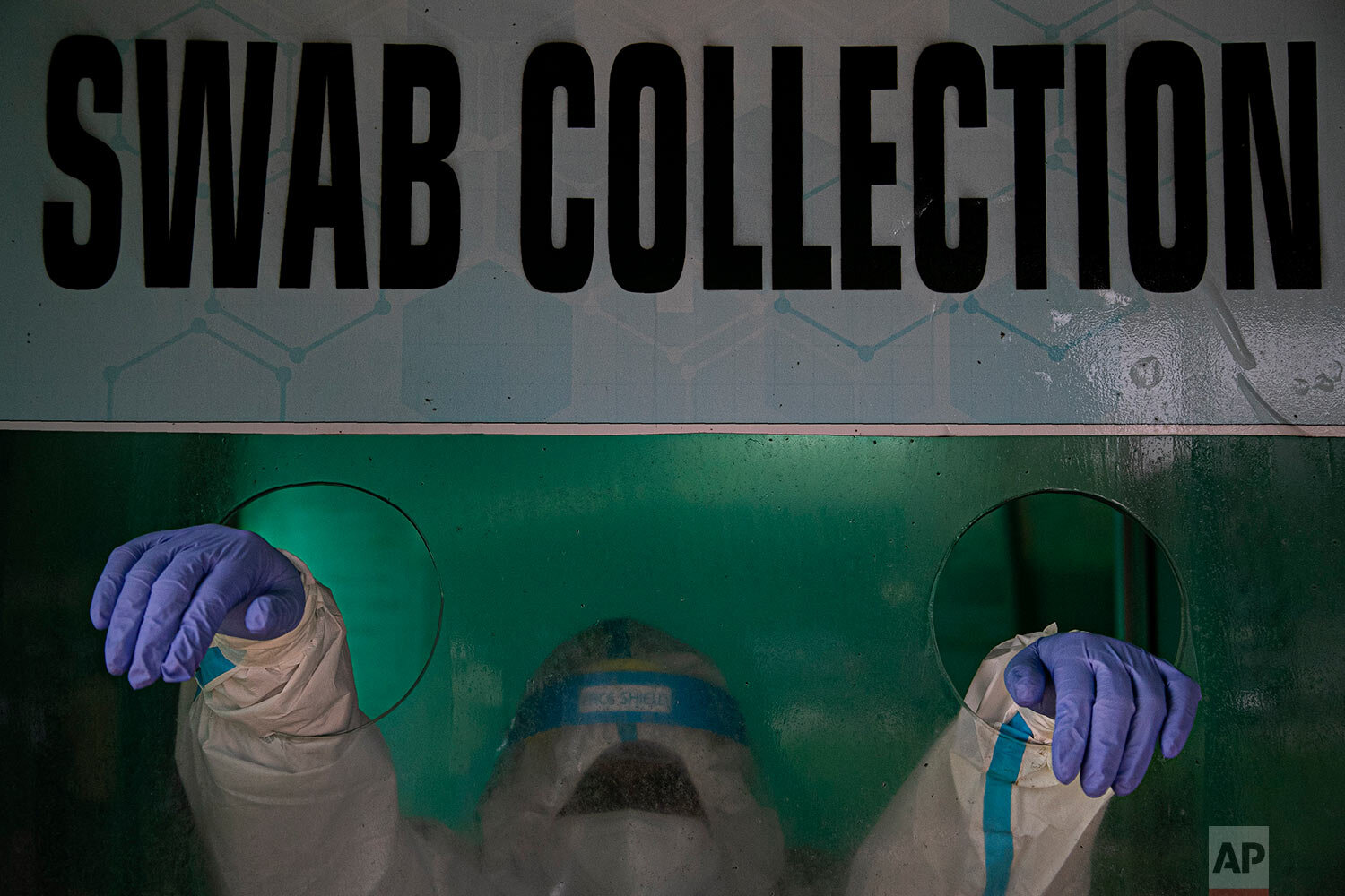  An Indian health worker waits to take a nasal swab sample to test for COVID-19 in a swab collection center in Gauhati, India, Monday, Aug. 17, 2020. (AP Photo/Anupam Nath) 