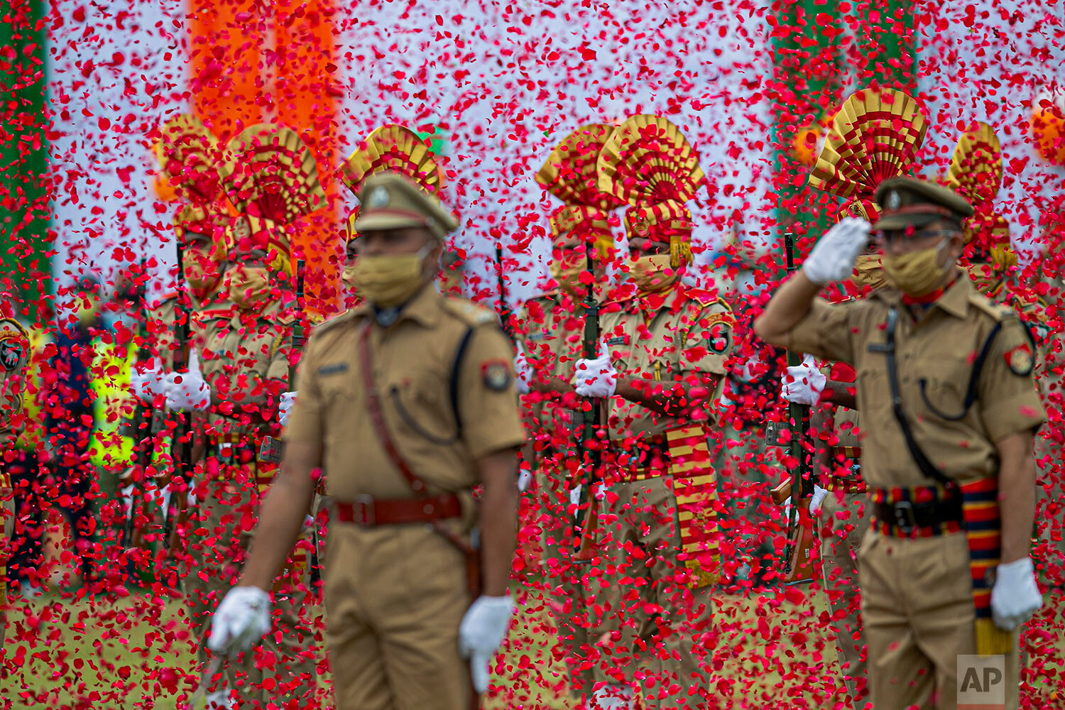  Flower petals fall on Indian paramilitary soldiers participating in an Independence Day parade in Gauhati, India, Saturday, Aug. 15, 2020. (AP Photo/Anupam Nath) 