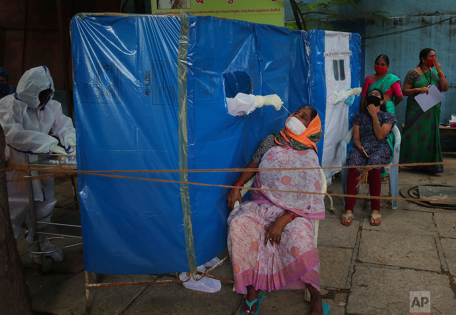  A health worker takes a nasal swab sample to test for COVID-19 in Hyderabad, India, Saturday, Aug. 22, 2020. (AP Photo/Mahesh Kumar A.) 