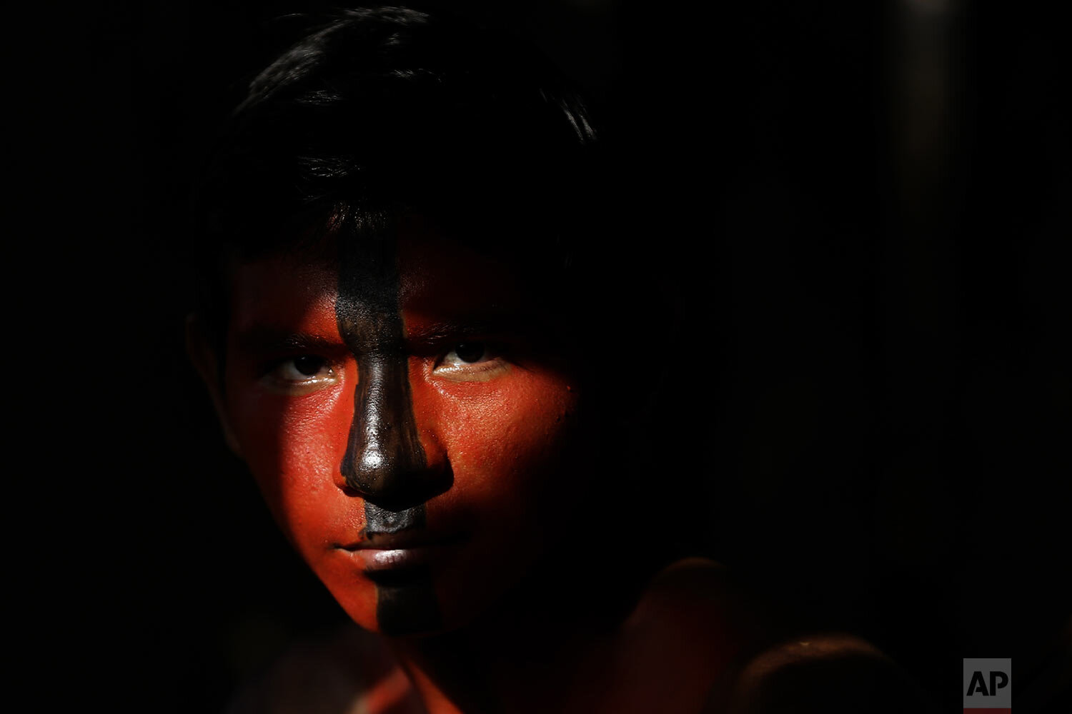  Tenetehara Indigenous Jair Tembe eyes the camera during a festival at the Alto Rio Guama Indigenous Territory, near Paragominas, in the northern Brazilian state of Para, Monday, Sept. 7, 2020. (AP Photo/Eraldo Peres) 