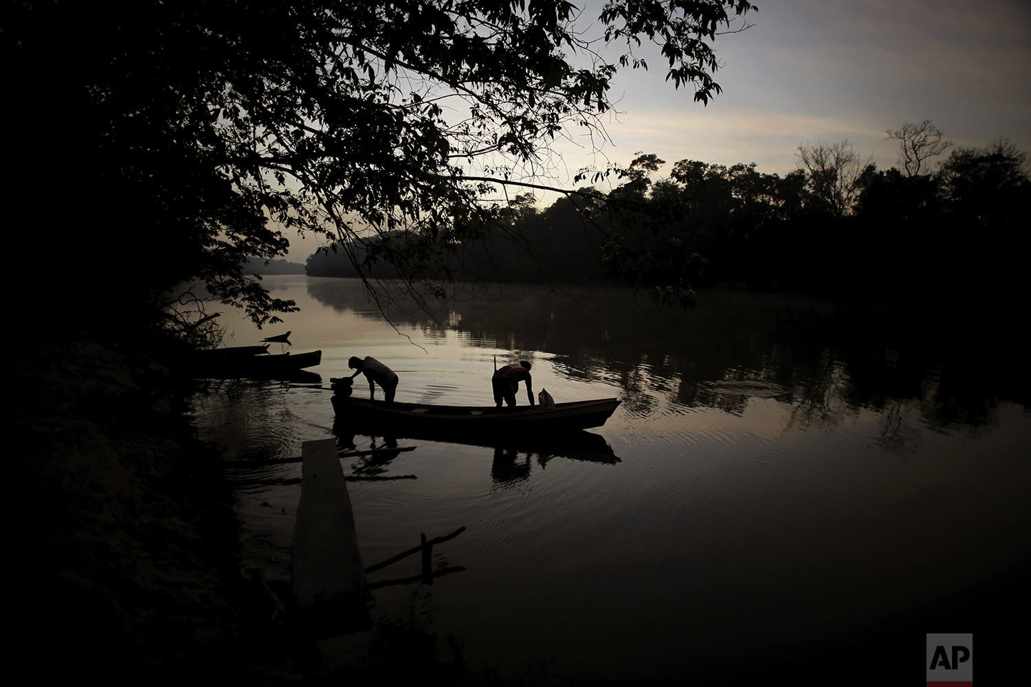  Tenetehara Indigenous men prepare to go out on their boat in the Gurupi River, in the Alto Rio Guama Indigenous Territory, near Paragominas, in the northern Brazilian state of Para, Monday, Sept. 7, 2020. (AP Photo/Eraldo Peres) 