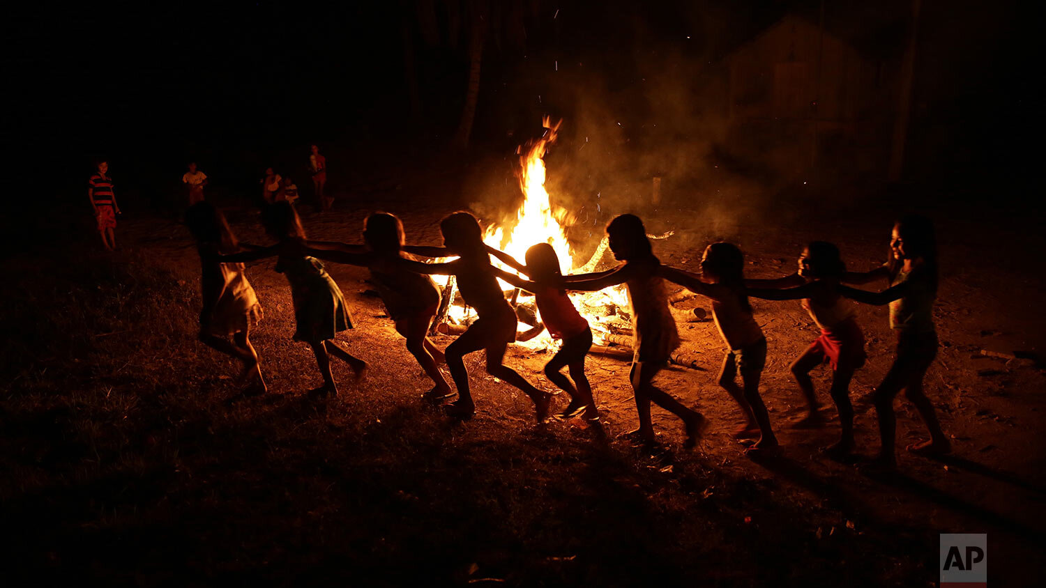  Tenetehara Indigenous children play around a campfire during a festival in the Alto Rio Guama Indigenous Reserve, near Paragominas, in the northern Brazilian state of Para, Monday, Sept. 7, 2020. (AP Photo/Eraldo Peres) 