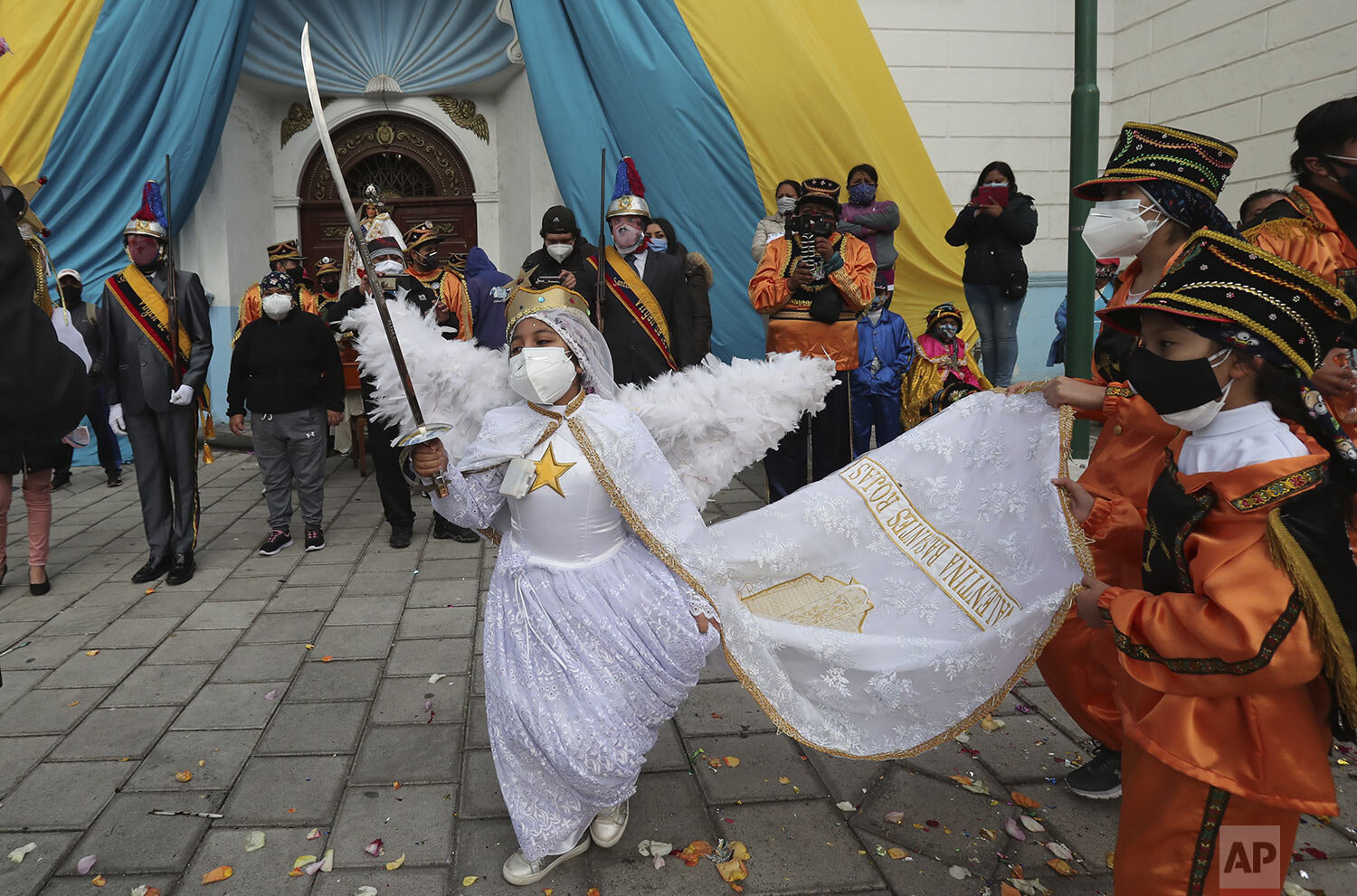  A character typical of the Mama Negra festival dances with a sword in honor of the Virgin of Las Mercedes in Latacunga, Ecuador, Sept. 24, 2020. The  festival dates back to 1742 when the people of Latacunga ask the Virgin to protect them from the er